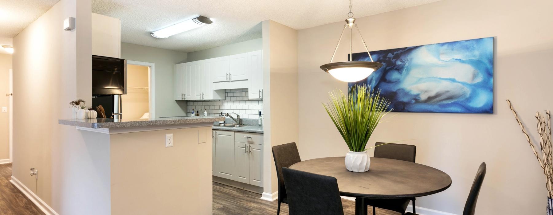 a kitchen with a dining table and chairs