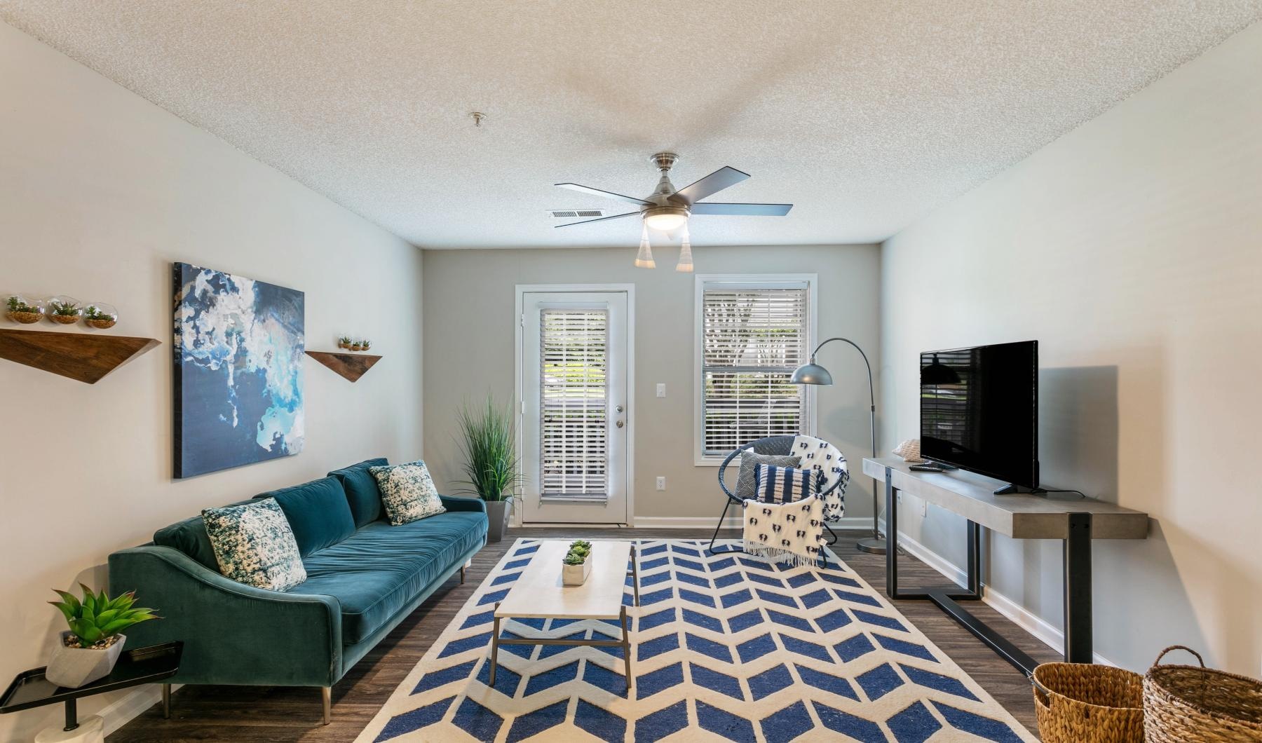 a living room with a blue couch and a rug