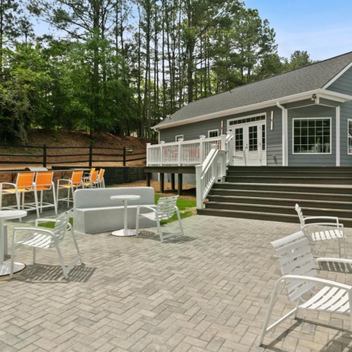a patio with tables and chairs