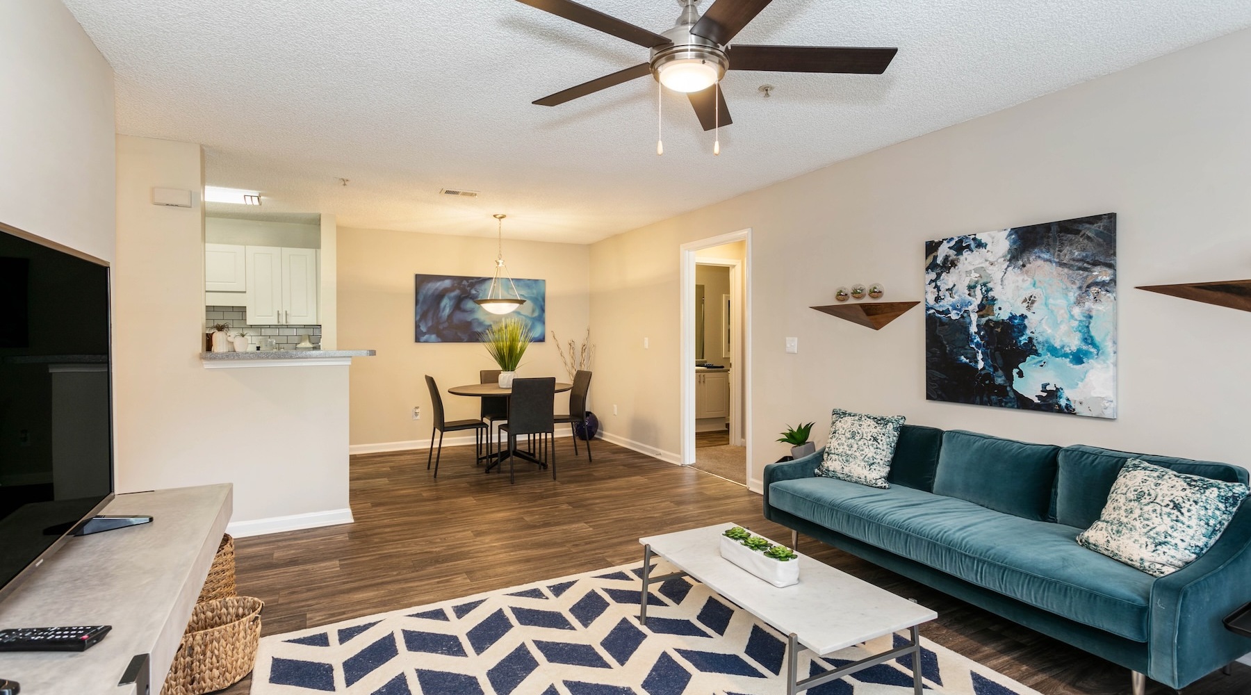 living room with furniture and a view of a kitchen