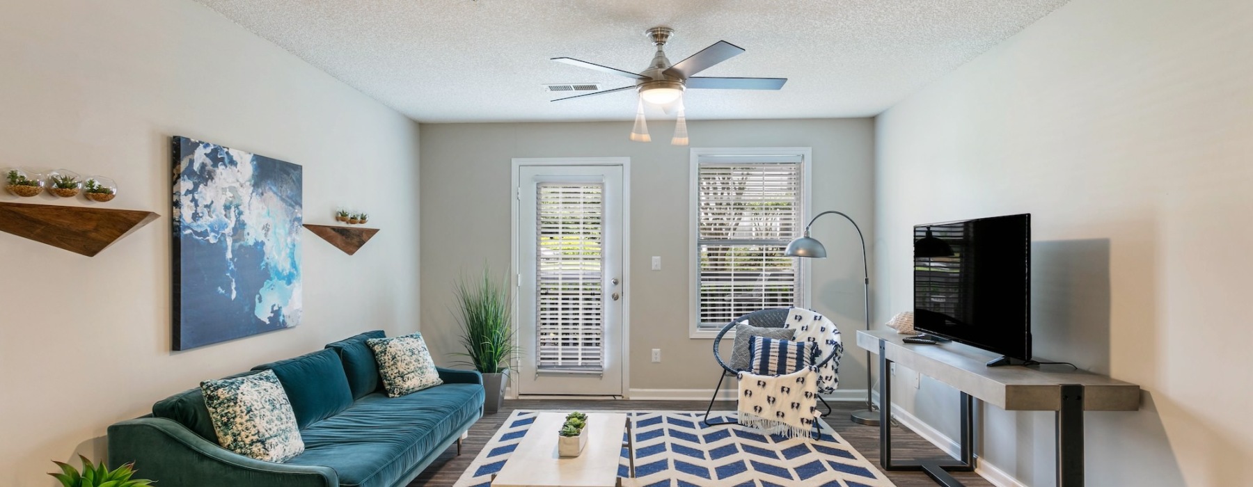 a living room with a blue couch and a rug