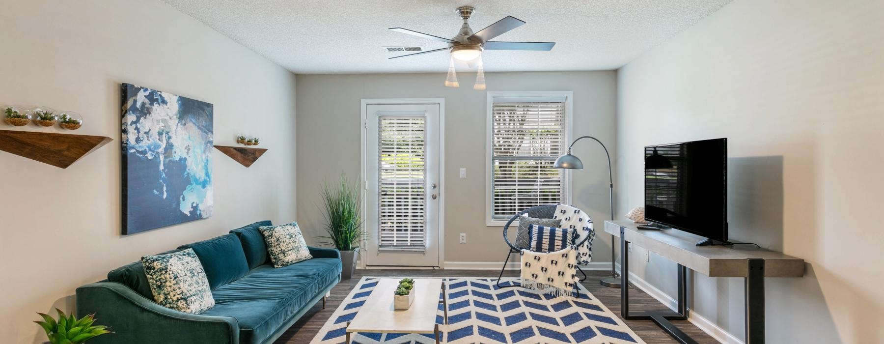 a living room with a blue couch and a rug